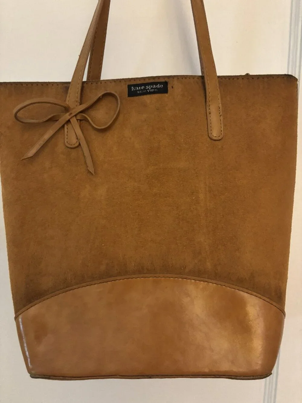 The Kate Spade New York tan suede and leather tote bag with bow